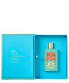A perfume bottle labeled 'Peach Bliss' by Nes Brooks, displayed inside an open turquoise gift box with a gold cap. The box lid features gold text reading 'LET YOUR SEDUCTION STORY BEGIN.