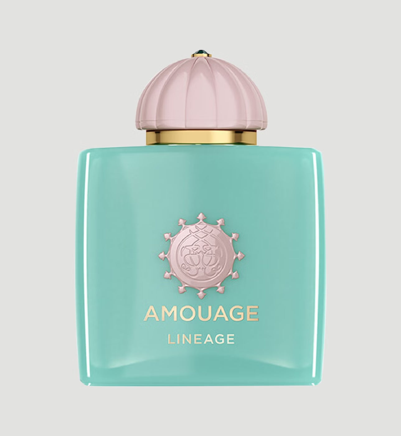 Amouage Lineage perfume bottle in a glossy mint green glass, featuring a ribbed light pink cap and gold lettering on a light gray background.