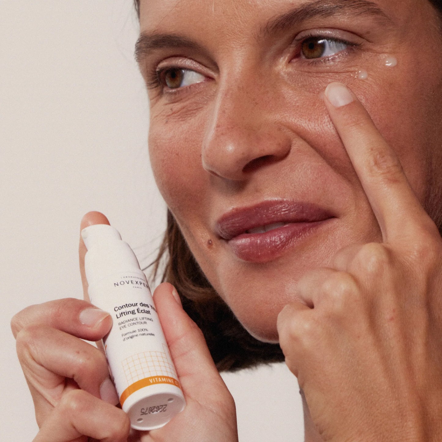 Woman applying Novexpert Radiance Lifting Eye Contour to her face at Mn  Mkanak