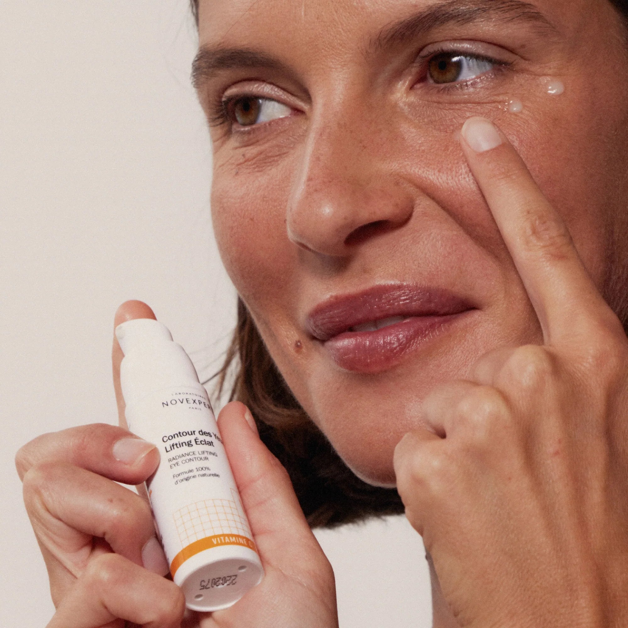 Woman applying Novexpert Radiance Lifting Eye Contour to her face at Mn  Mkanak