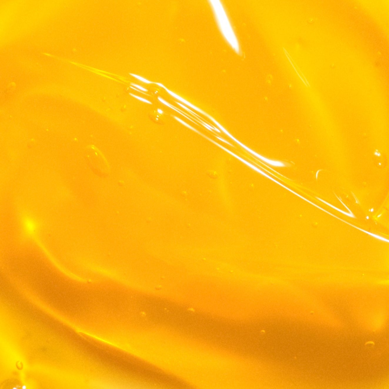 Close-up of yellow liquid with a glossy surface