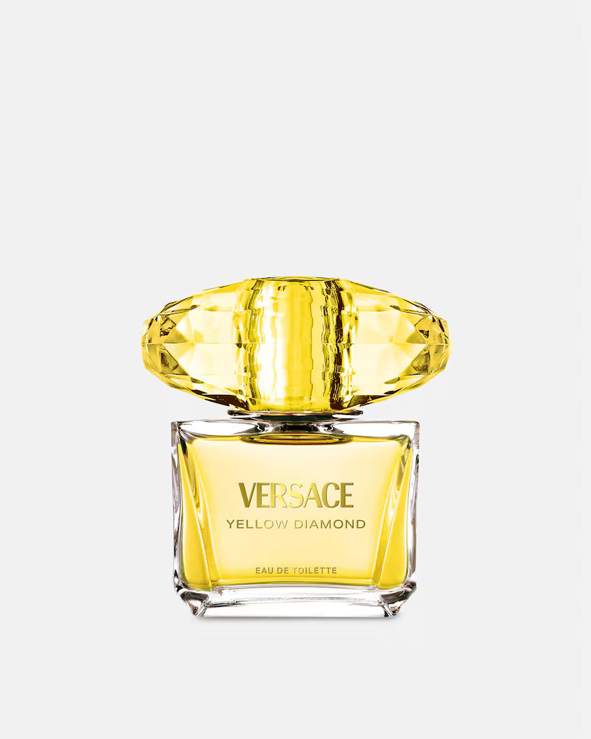 Versace Yellow Diamond Eau de Toilette perfume bottle with a faceted yellow cap and yellow liquid, shown on a light gray background.