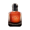 Emporio Armani Stronger With You Absolutely Eau de Toilette bottle, featuring a square glass container with a warm amber-orange liquid, a black textured neck, and a spherical black cap, set against a plain white background.