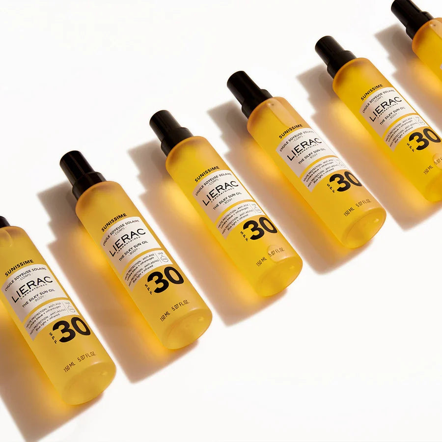 Multiple bottles of Lierac sun care product on a white background